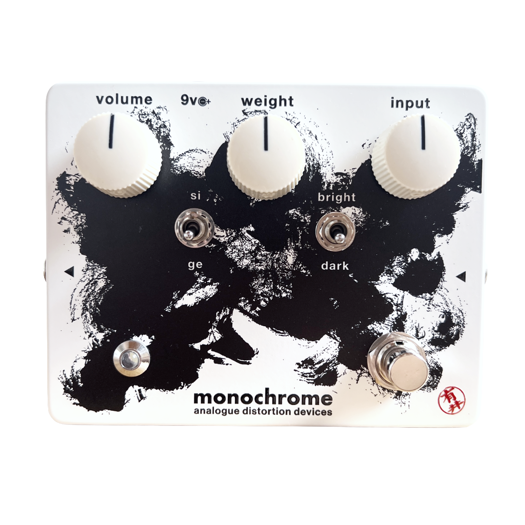 Guitar effects pedal with control knobs and switches on a black and white background, featuring 'monochrome analogue distortion devices' branding.