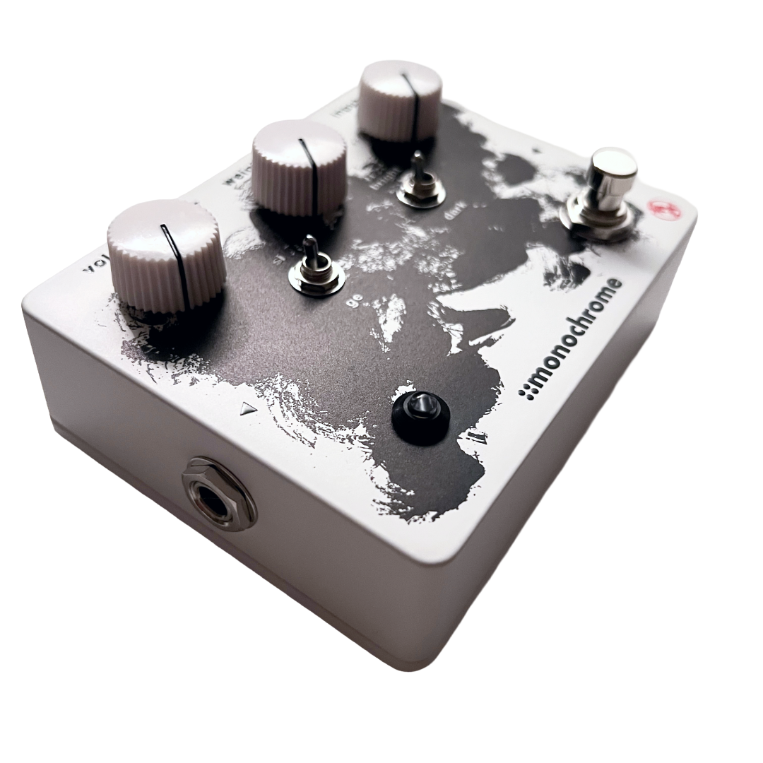 Guitar effects pedal with 'monochrome' branding on a white background