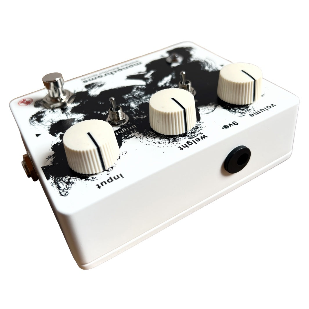 White guitar effects pedal with black design on a white background
